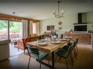 a dining room and living room with a table and chairs at Lodge Cresson - OVO Network in Châtel