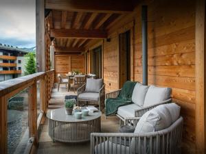 a porch with chairs and a table on a cabin at Lodge Cresson - OVO Network in Châtel +13 photos
