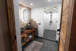 a bathroom with two sinks and a shower at Ferienhaus Köck in Kartitsch
