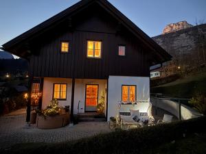 een zwart huis met kerstverlichting ervoor bij Villa Verdi in Fischerndorf