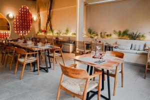 a restaurant with wooden tables and chairs and a couch at Paul Marie in Hersonissos