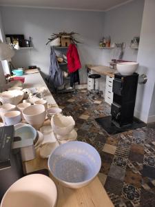 a room with a bunch of bowls on a table at Ferienhaus "Zum Blauen Hause" in Wernigerode +27 photos