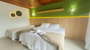 Voodi või voodid majutusasutuse Hotel Pé na Areia toas