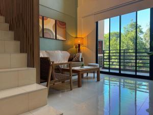 a living room with a couch and a table at Iguazu Lofts in Puerto Iguazú