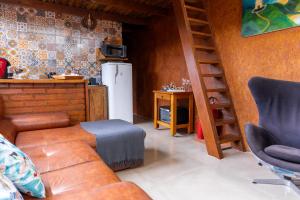 a living room with a couch and a refrigerator at Pousada e Chalé Lote 22 in Ilha do Mel