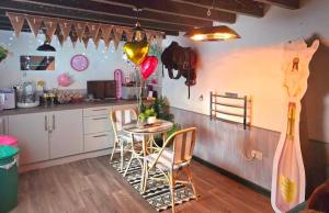 a kitchen with a table and chairs in a room at The Stable Annexe with hot tub & horses in Dogdyke