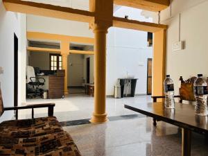 a living room with a pillar and a table at Hostel Dara Jaisalmer in Jaisalmer
