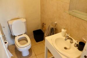 a bathroom with a toilet and a sink at Casa Slide en Chapadmalal in Colonia Chapadmalal +10 photos