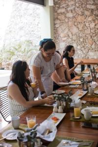 a group of people sitting at a table at TreeHouse Boutique Hotel, an adults only boutique hotel in Mérida +14 photos