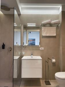 a bathroom with a sink and a shower and a toilet at B&B Cariddi Rooms in Caltanissetta