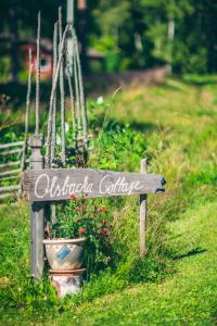 a sign that says oakridge cottage in a garden at Olsbacka cottage in Falun