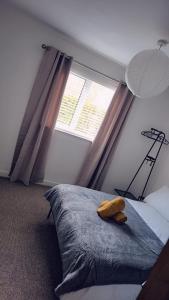 a bedroom with a large bed and a window at Cockermouth Cottage - Lakes - Parking in Cockermouth