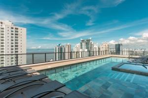 a swimming pool on the roof of a building at Furnished Deluxe Condo Suite 2BR with View in Panama City