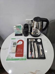 a table with a coffee pot and a box on it at Eco Hotel in Hanoi