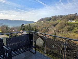 a bench sitting on top of a balcony at Malerischer Panoramablick Worgberg in Ingelfingen