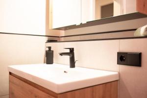 a bathroom with a white sink and a mirror at kleines KunzGlück in Waldbronn +24 photos