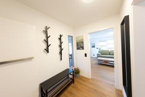 a living room with white walls and a tv and a couch at kleines KunzGlück in Waldbronn