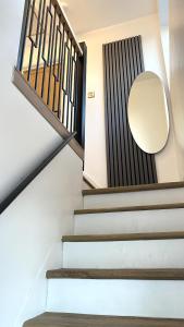 a staircase with a round mirror on the wall at Ready Stay Work Lodge in Birmingham