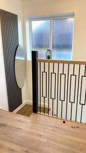 a room with a hallway with a mirror and a window at Ready Stay Work Lodge in Birmingham