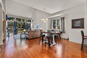 a dining room and living room with a table and chairs at Aspen Retreat - Meredith Lodging in Redmond