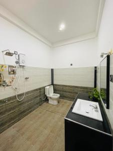 a bathroom with a toilet and a sink at Ivy Villa - Tangalle in Tangalle