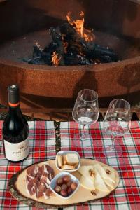 a table with a plate of food and a bottle of wine at Canhoto Douro in Marco de Canaveses