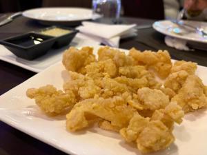 a white plate of food on a table at OTAKS1 Waterside stunning 4b villa 80 metres from the beach with all amenities nearby & a large pool in Grand Baie