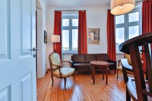 a living room with a couch and a table at Riverside Apartments in Lübeck
