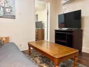 Johnson CityCheerful Studio short walk to UHS near Lourdes & BU的客厅配有电视和木制咖啡桌 更多6张照片