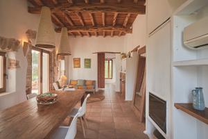 a kitchen and dining room with a table and chairs at Ibiza Holliday Villa Harmony in Sant Jordi