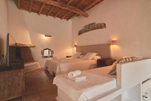 a hotel room with two beds and a television at Ibiza Holliday Villa Harmony in Sant Jordi +70 photos