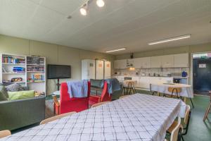 a kitchen with a table and chairs in a room at Godby Vandrarhem in Godby