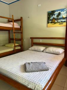 a bedroom with two bunk beds and a ladder at Pousada Imperio dos Bambus in Jijoca de Jericoacoara