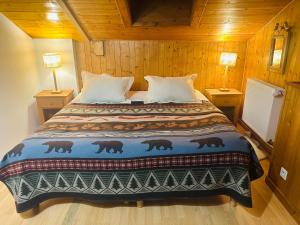 a bedroom with a bed in a wooden room at Maison du Bourg in Samoëns