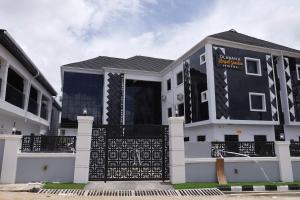 a black and white house with a black gate at Olabanji Royal Garden Hotel in Ibadan +21 photos