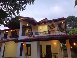 a white house with black shutters on it at Ivy Villa - Tangalle in Tangalle +32 photos