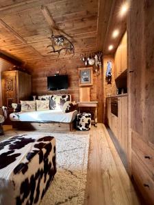 a bedroom with a bed with cow pillows at Ciasa de Len Cortina in Cortina dʼAmpezzo