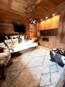 a bedroom with a bed and a television in a room at Ciasa de Len Cortina in Cortina dʼAmpezzo