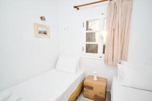 Diamantis Kitesurf Residencies في ميكري فيغلا: غرفة بيضاء بها سرير ونافذة