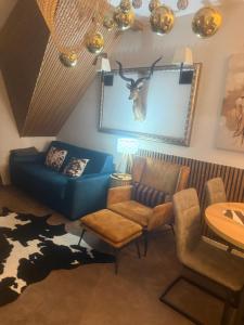 a living room with a blue couch and a table at Аpartman 511 Zupa in Kopaonik