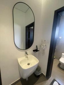 a bathroom with a white sink and a mirror at Najd Hotel in AlUla