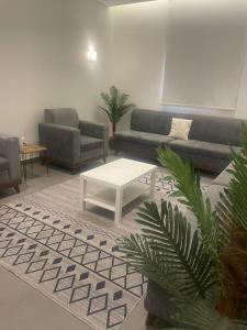 a living room with a couch and a coffee table at Najd Hotel in AlUla