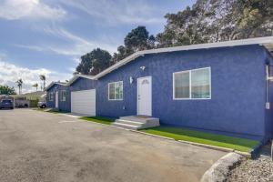 a blue house with a car parked in front of it at Walk to Dining and Chula vista Center Modern Duplex in Chula Vista