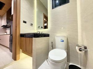 a bathroom with a white toilet and a sink at Chalong Brand New 4BR Pool Villa Phuket VVPHU51 in Chalong  +7 photos