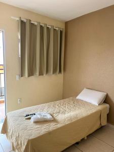 Ένα ή περισσότερα κρεβάτια σε δωμάτιο στο Hotel Portal do Eden