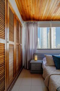 a bedroom with a bed and a window with a view at Habitación doble baño privado cerca al mar y bahia in Cartagena de Indias