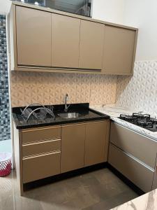 a kitchen with a sink and a stove at Centro de união da vitória in União da Vitória
