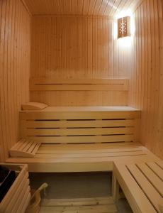 a sauna with a bench and a light in it at Chiflika Family Hotel in Asenovgrad +68 photos