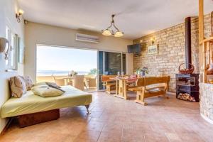 a bedroom with a bed and a dining room with a table at Villa Casa with indoor pool in Krilo