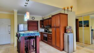 a kitchen with wooden cabinets and a counter top at Ocean Dream Studios Cabarete in Cabarete